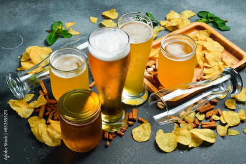 Beer banner. A set of different types of beer in glasses and snacks. Top view.