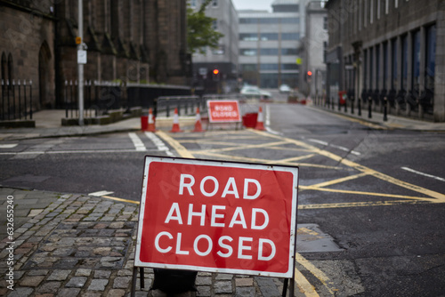 Road ahead closed sign on empty Main Street in the city.