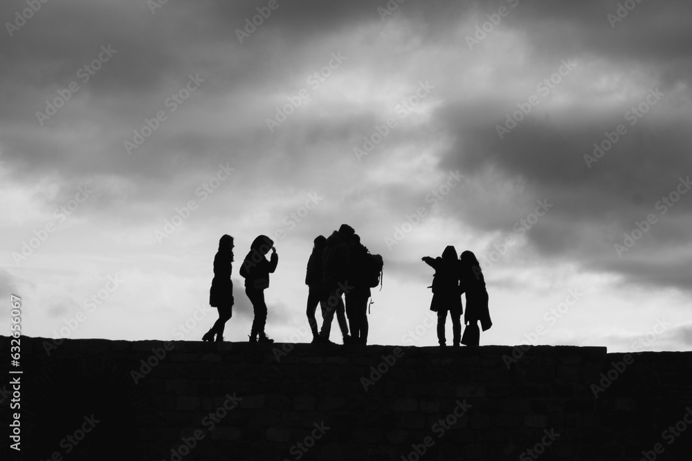 group of people walking on a hill