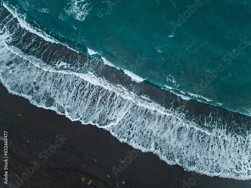  black volcanic sand beach of ocean with blue water waves, Tenerife, aerial view
