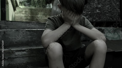 Sad lonely boy alone on the steps. Concept of loneliness, bullying, mental health problems in blowers and teenagers