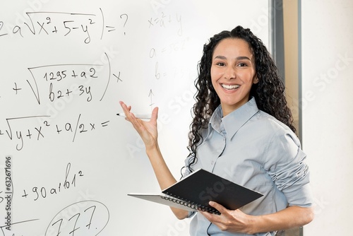 Female young Hispanic university teacher, college tutor explaining math giving remote school class online lesson teaching looking at camera in classroom by E-Learning video conference zoom call.