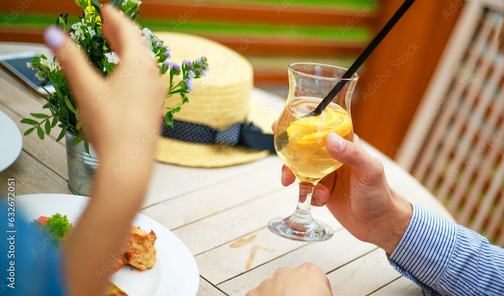Happy couple talking while having picnic on a patio. summer time in backyard garden with appetizers and light snacks Happy couple talking while having picnic on a patio. summer time in backyard garden with appetizers and light snacks