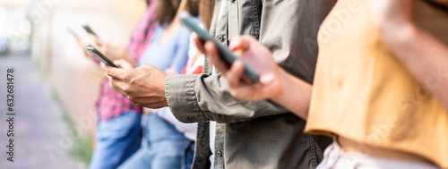 Horizontal banner with bored friends group using smartphone sitting at university backyard - Young people addicted by mobile smart phone - Technology sad life concept with always connected students