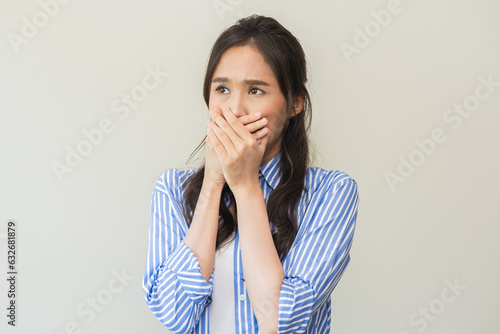 Portrait of pretty brunette hair, disgust smell bad breath strong asian young woman shocked covering, close her mouth with hand, expression face disgusting, dislike odor. Isolated on white background.