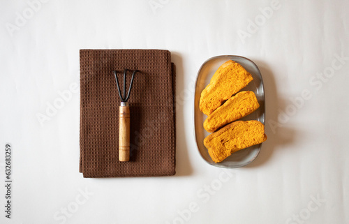 Yellow rusks with a small garden fork minimal flat lay