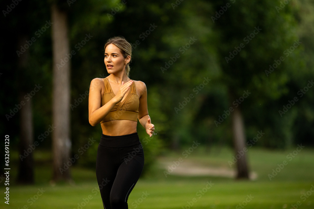 Pretty young woman running in the park Pretty young woman running in the park