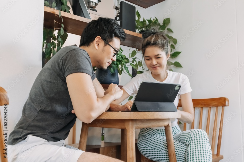 Asian man and woman dealing business agreement and contract in relaxing office. Asian man and woman dealing business agreement and contract in relaxing office.