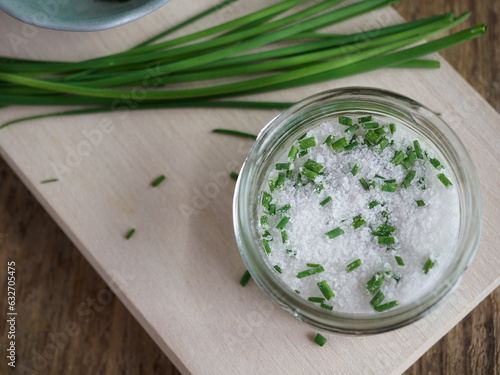 Green fresh organic chives mixed with salt. Ingredient for cooking. Overhead shot. 