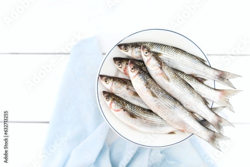 Mullet, Loban, Buri, on a white wooden table, seafood, top view, place for text, background photo