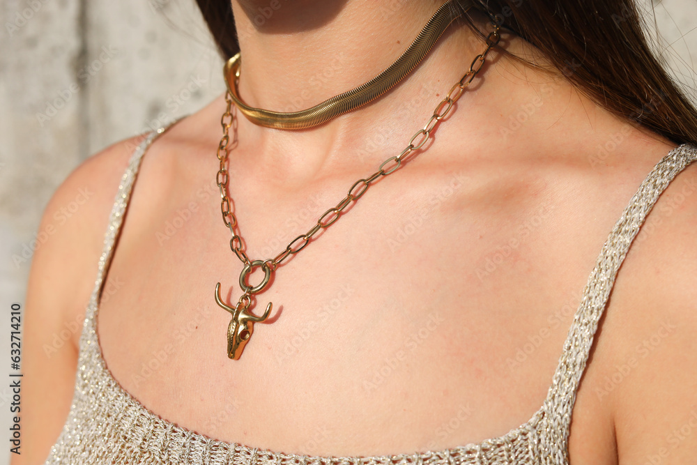 Stylish fashion model women jewelry. Female neck wearing modern gold necklace. Autumn trendy jewel accessories.
