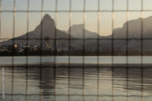 Rodrigo de Freitas lagoon  (Lagoa Rodrigo de Freitas) seen from behind the bars during sunset in Rio de Janeiro. photo