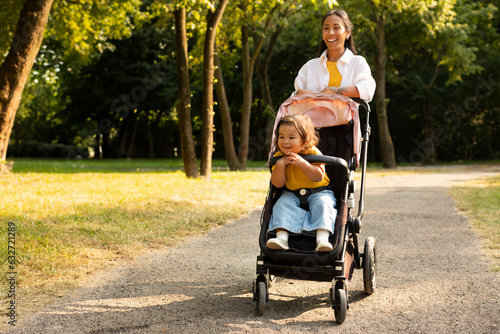 Принти на полотні Japanese Mom Walking With Toddler Daughter In Stroller At Park