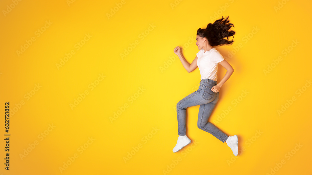 Happy Lady Running In Mid Air Looking Aside, Yellow Background