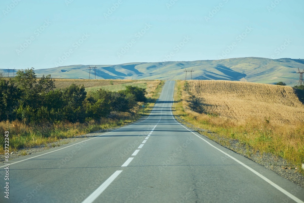 Country highway in the autumn. Empty roads among the hills Country highway in the autumn. Empty roads among the hills