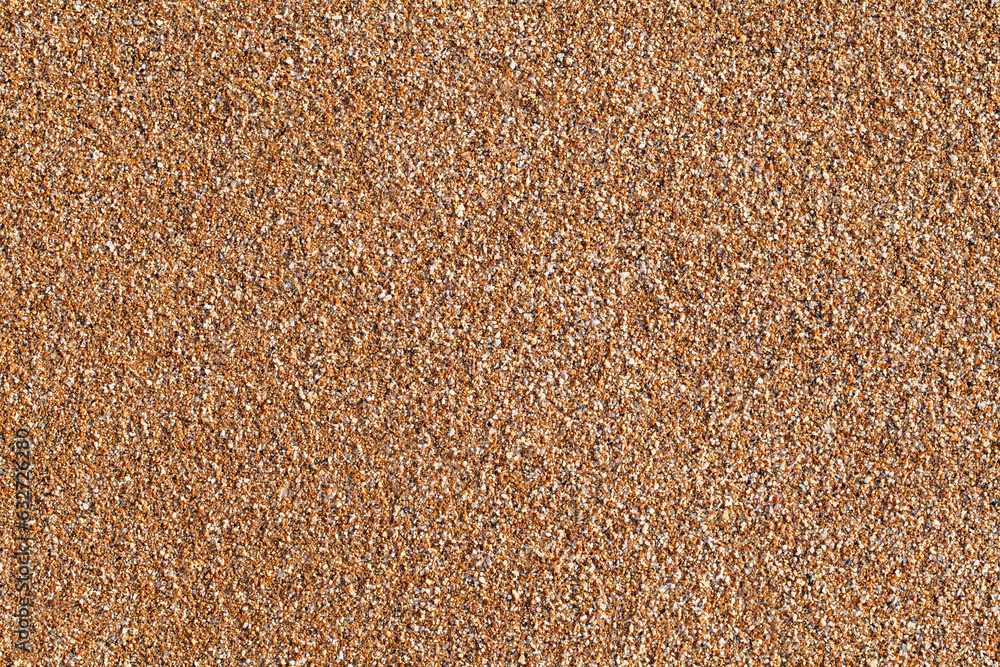 Yellow beach sand from small parts of shells close-up, uniform texture background Yellow beach sand from small parts of shells close-up, uniform texture background
