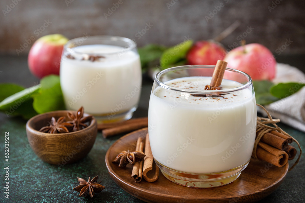 Autumn still life Background. Healthy nutrition: apple smoothie with cinnamon on a dark stone background. Copy space. Autumn still life Background. Healthy nutrition: apple smoothie with cinnamon on a dark stone background. Copy space.