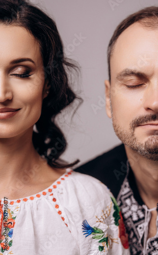 Portrait of loving brides couple, couple in embroidered shirts national ornamets