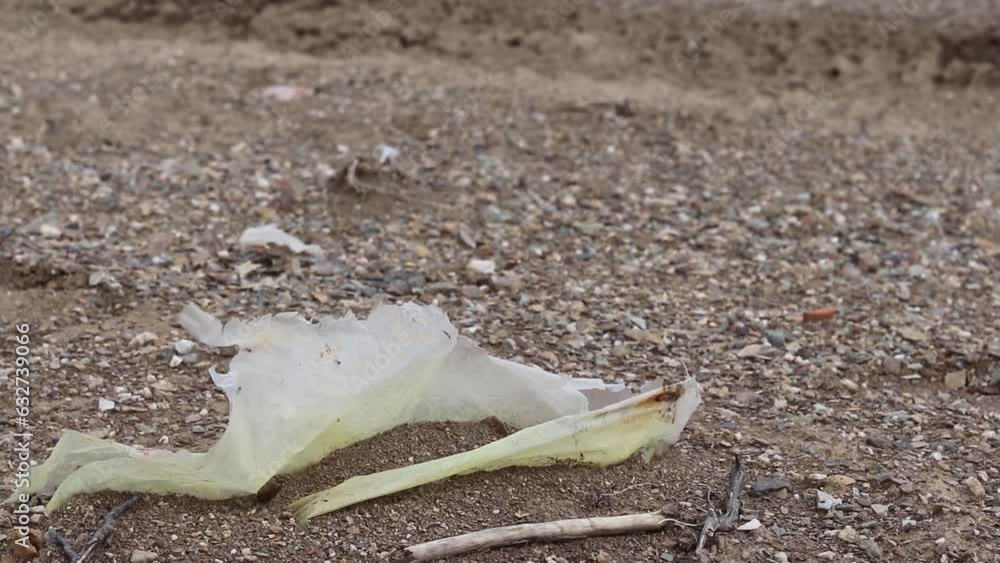Rotten nylon plastic material on beach. Non-biodegradable garbage on ground, earth pollution, environmental issues concept. Rotten nylon plastic material on beach. Non-biodegradable garbage on ground, earth pollution, environmental issues concept.