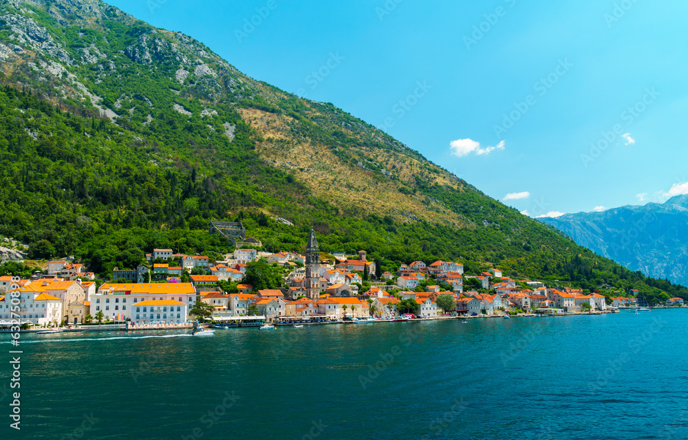 seascapes, a view of the Bay of Kotor during a cruise on a ship in Montenegro, a bright sunny day, mountains and small towns on the coast, the concept of a summer trip