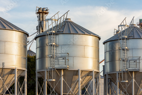 Sunset in the field. Silos for grain storage