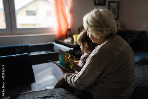 senior grandmother woman and grandchild small child toddler girl photo