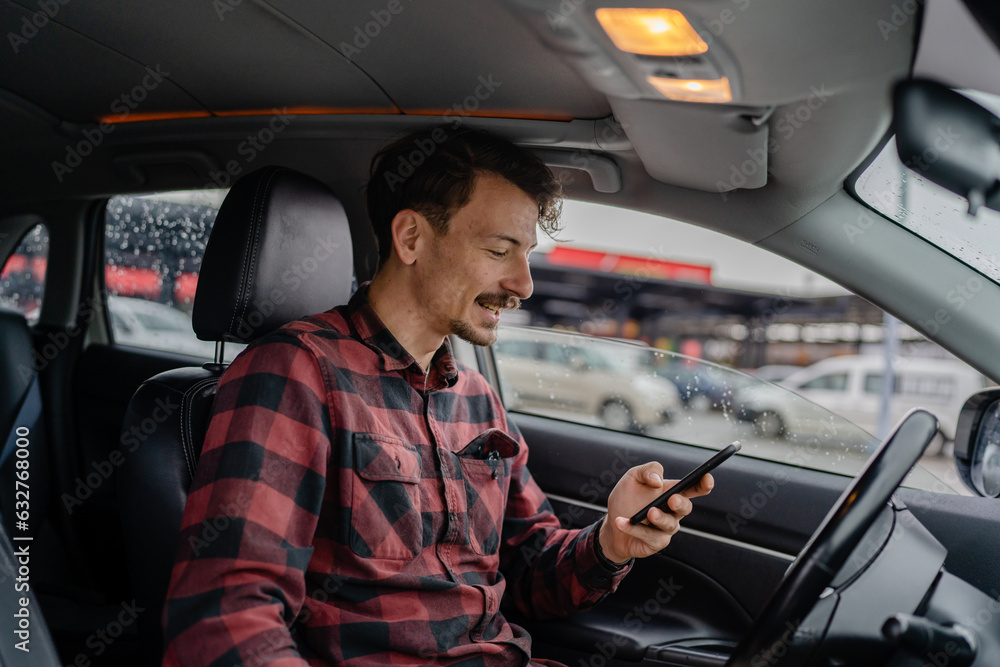 one adult man caucasian with mustaches sit in car use mobile phone one adult man caucasian with mustaches sit in car use mobile phone