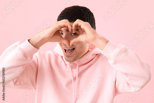 Young man making heart with...