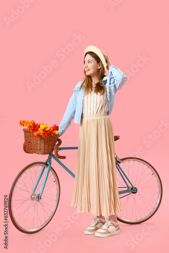 Young woman with bicycle on...