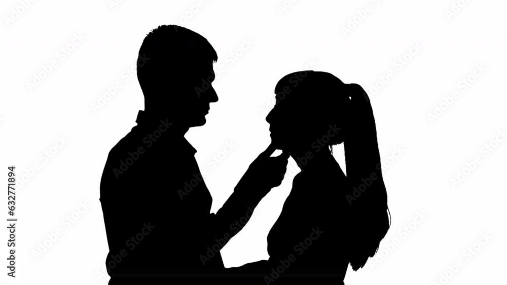 Silhouette of a kissing couple of a man with a woman. black and white mask