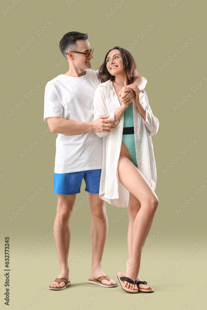 Young couple in summer clothes hugging on green background Young couple in summer clothes hugging on green background
