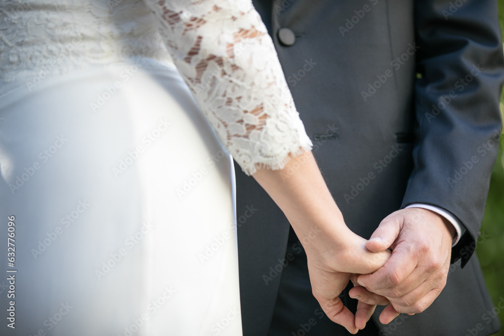 close up of hands of bride and groom