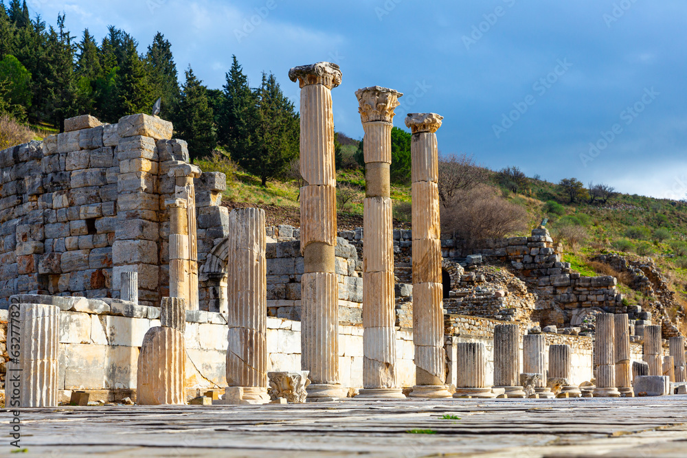 Ruins of the Upper Agora in the ancient city of Ephesus in Turkey. View of fragments of columns with Sacred Street and Odeon