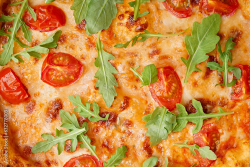 Texture of tasty pizza Margarita with tomatoes and arugula as background