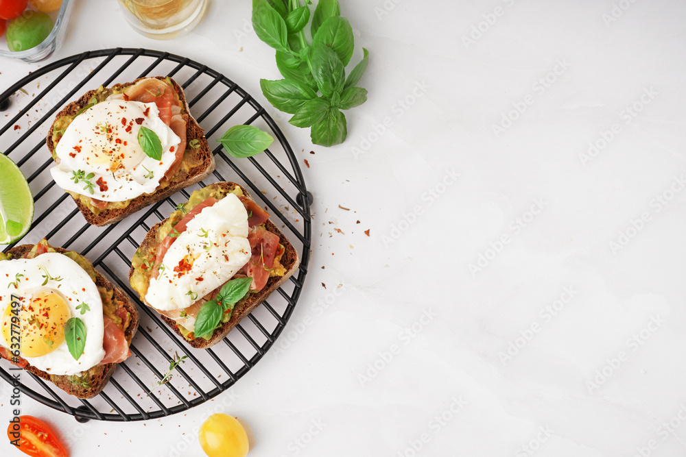 Grid of tasty sandwiches with egg on grey background