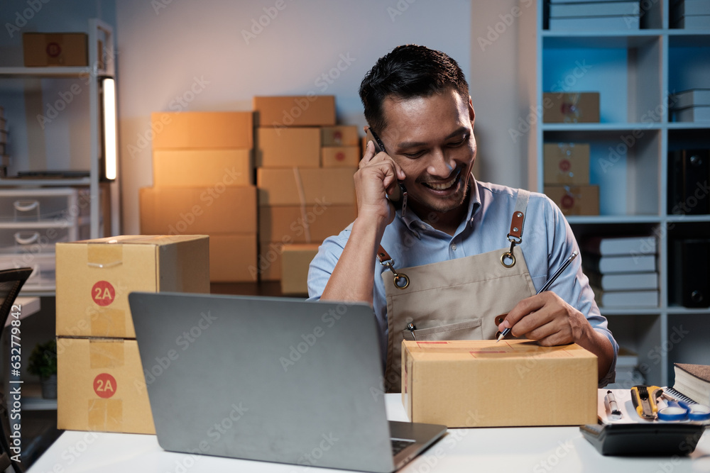 Happy motivated small business owner having a phone call with his partner at night, discussing the work progress. Happy motivated small business owner having a phone call with his partner at night, discussing the work progress.