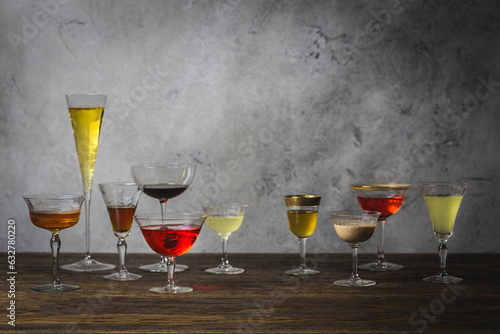 Array of various cocktail, wine and champagne glasses arranged on wood table