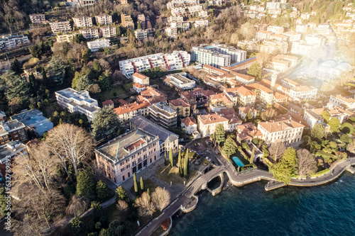 Aerial view of the cityscape of Como at sunrise with villas and traditional houses