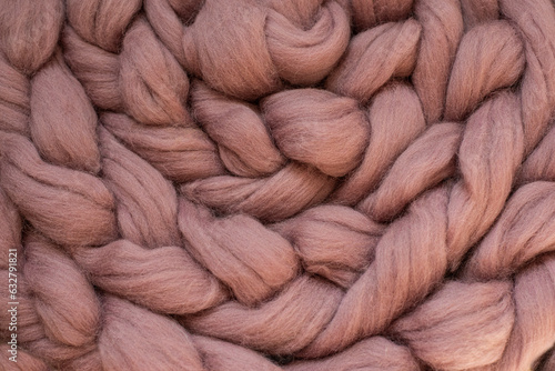 weave in the form of a braid of woolen fluffy threads close-up. 