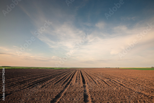 Selective blur on furrows on a Agricultural landscape near a farm, a plowed field in the countryside of Titelski, Serbia, Voivodina. The plough is a technique used in agriculture to fertilize a land. photo