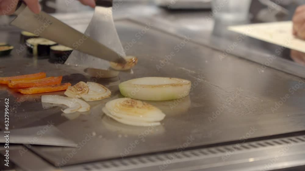 Japanese Chef cut slice onion over teppanyaki table side dish for Wagyu kobe authentic Meat Osaka Japan Japanese Chef cut slice onion over teppanyaki table side dish for Wagyu kobe authentic Meat Osaka Japan