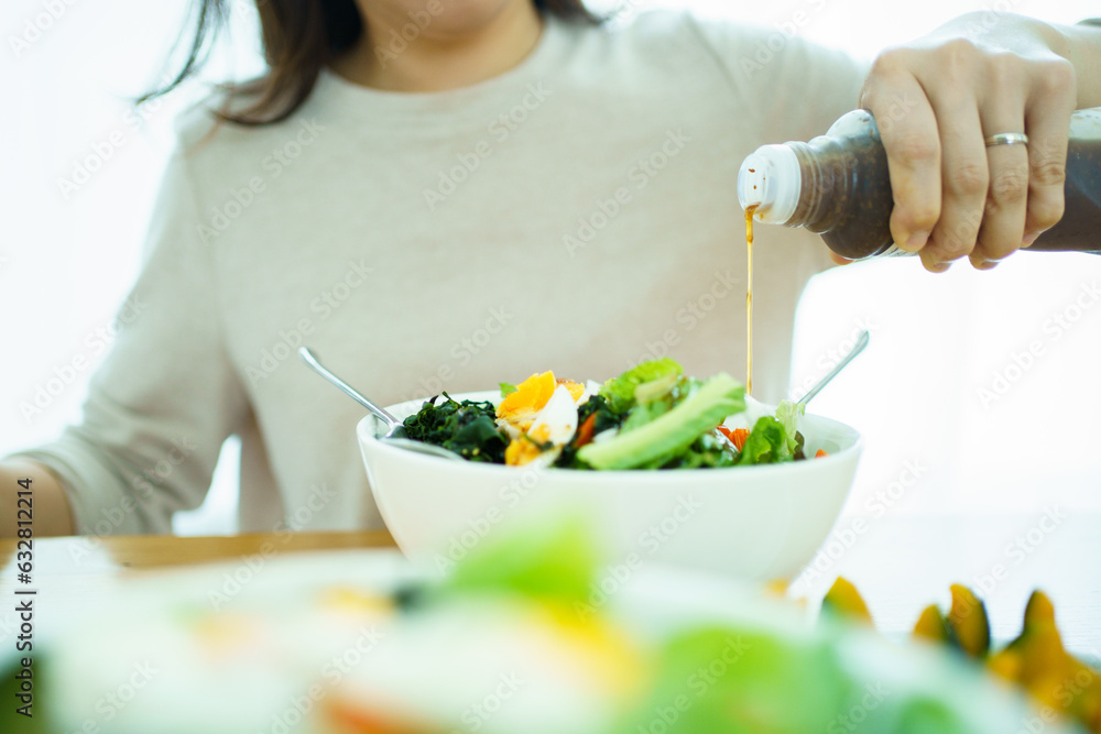 Happy Asian beautiful woman enjoy eating a vegetable salad with boiled eggs. Healthy eating lifestyles concept. Happy Asian beautiful woman enjoy eating a vegetable salad with boiled eggs. Healthy eating lifestyles concept.