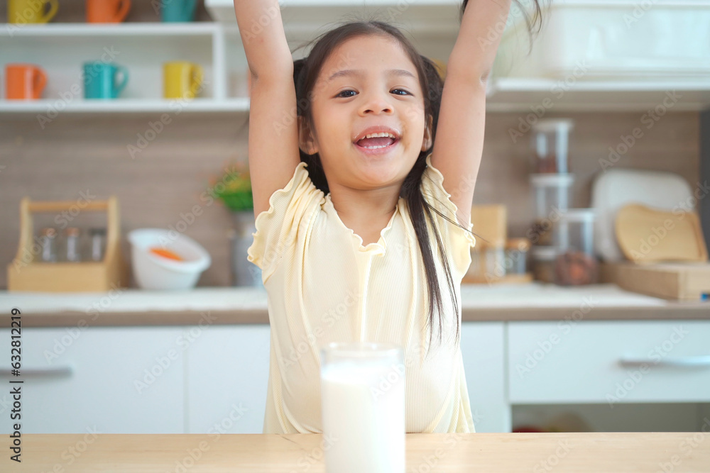 Happy cheerful lovely Asian little girl enjoy drinking a milk in glass, cute girl drinks a fresh milk in morning after breakfast. Happy cheerful lovely Asian little girl enjoy drinking a milk in glass, cute girl drinks a fresh milk in morning after breakfast.