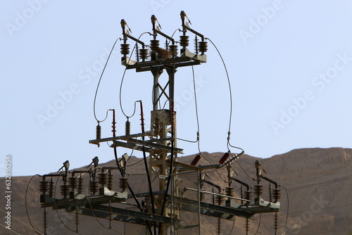 Power electric pole with line wires on insulators.