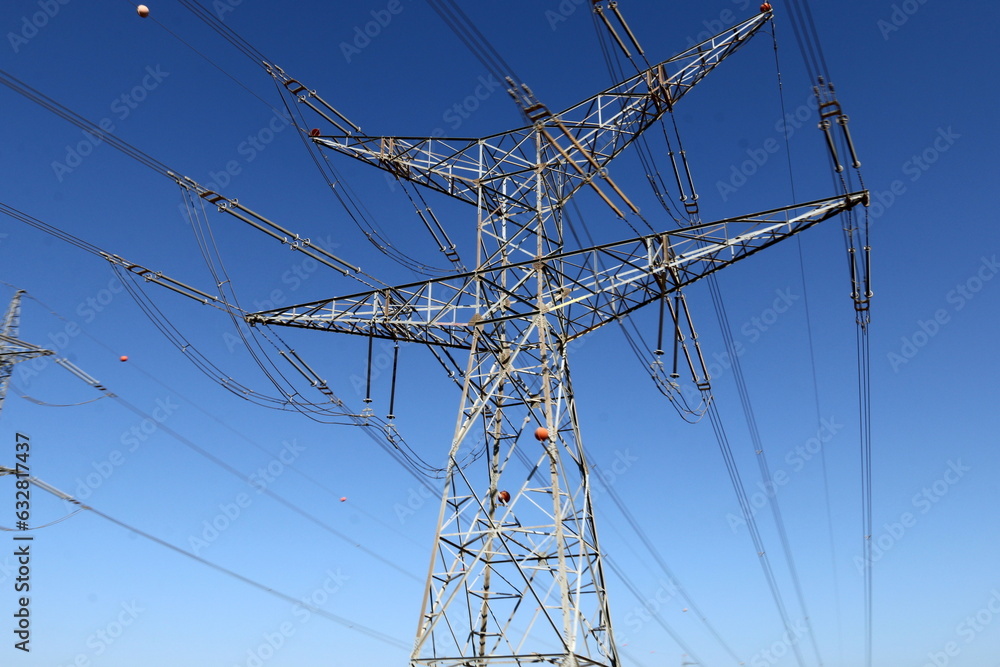 Power electric pole with line wires on insulators.