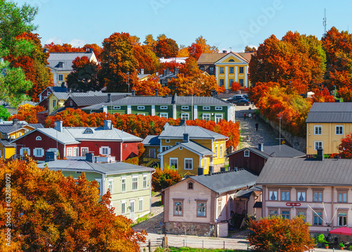 Finnish town Porvoo in Finland with autumn colors. Yellow and red trees and nice wooden buildings. Good tourism town Porvoo with colorful autumn theme. Color composition. 