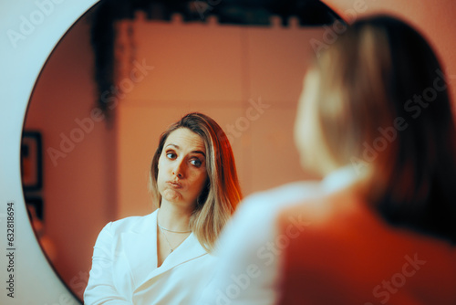 Fotografie Bored Unhappy Stylish Woman Looking in the Mirror
