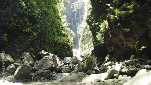 Static shot of a hidden waterfall that leads to a river in Hawaii. Shot in 4k at 60 frames per second photo