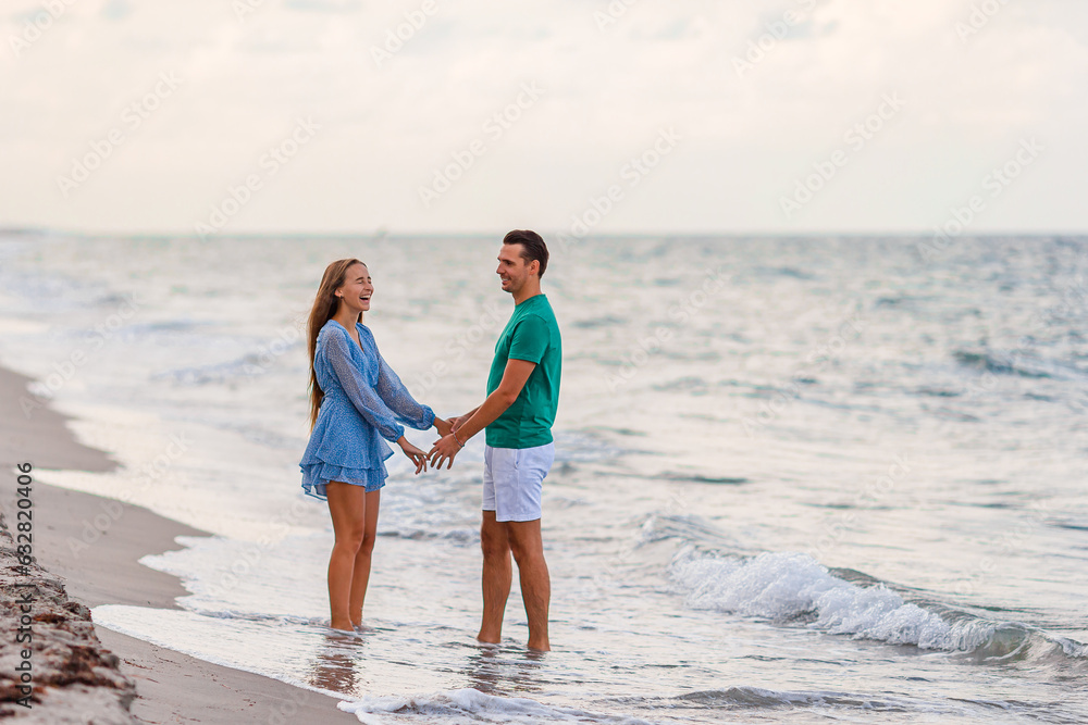 Adorable girl and happy dad having fun during beach vacation Adorable girl and happy dad having fun during beach vacation