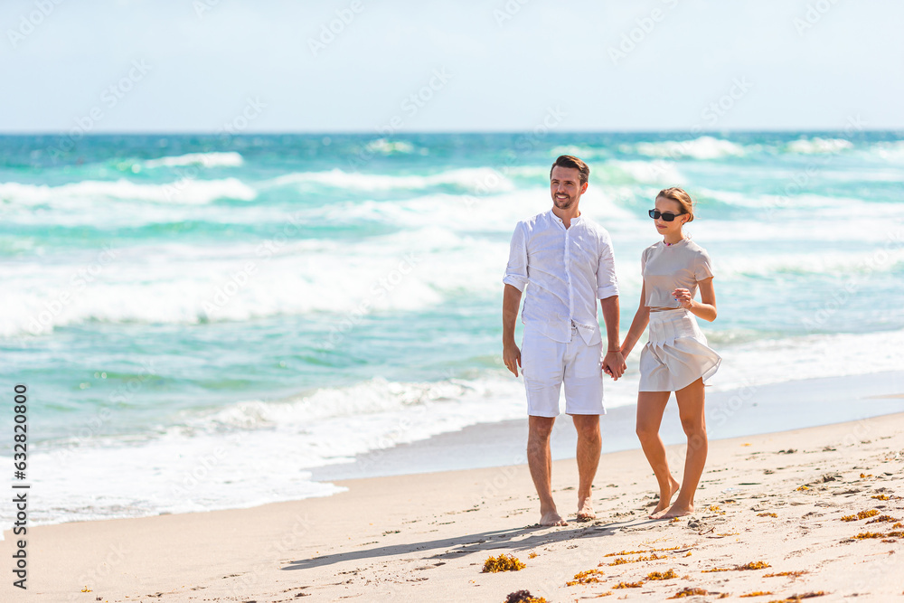 Adorable girl and happy dad having fun during beach vacation
